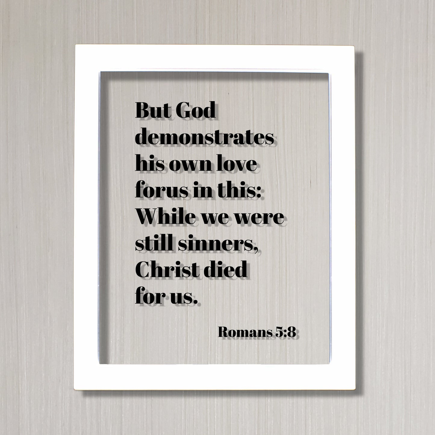 Romans 5:8 - But God demonstrates his own love for us in this While we were still sinners Christ died for us - Scripture Frame - Bible Verse