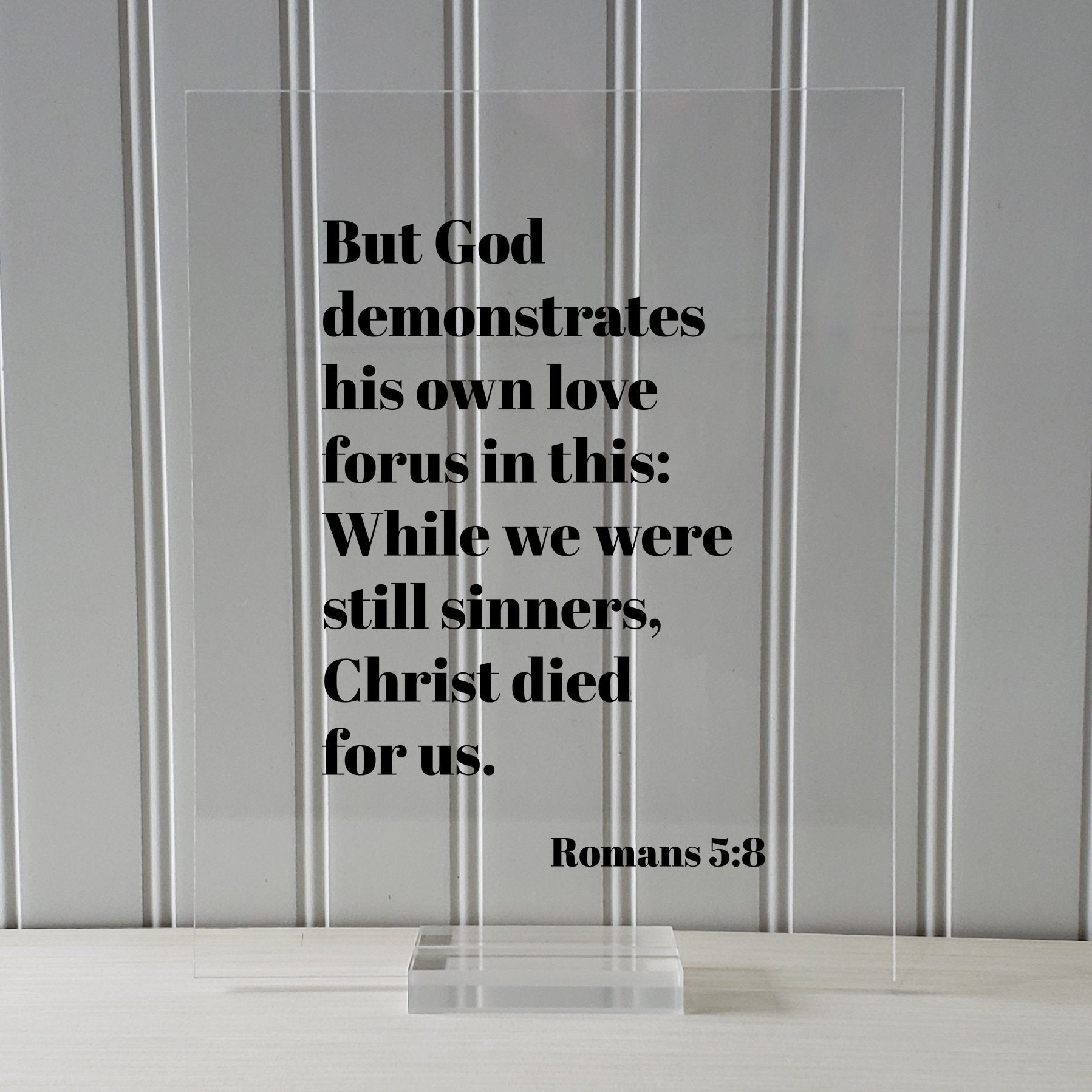 Romans 5:8 - But God demonstrates his own love for us in this While we were still sinners Christ died for us - Scripture Frame - Bible Verse