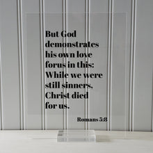 Romans 5:8 - But God demonstrates his own love for us in this While we were still sinners Christ died for us - Scripture Frame - Bible Verse